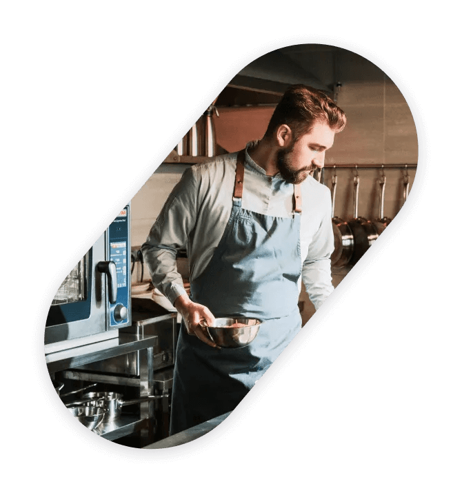 Oval frame photograph with a man cooking on a kitchen