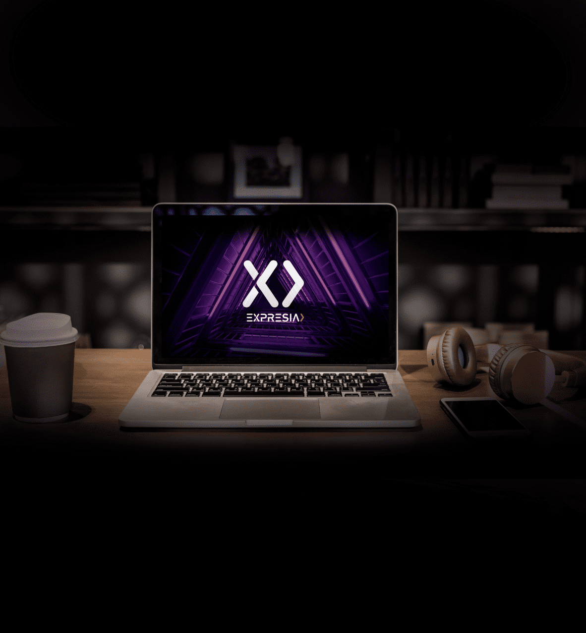 Picture of a laptop under a spotlight with an Expresia's background
