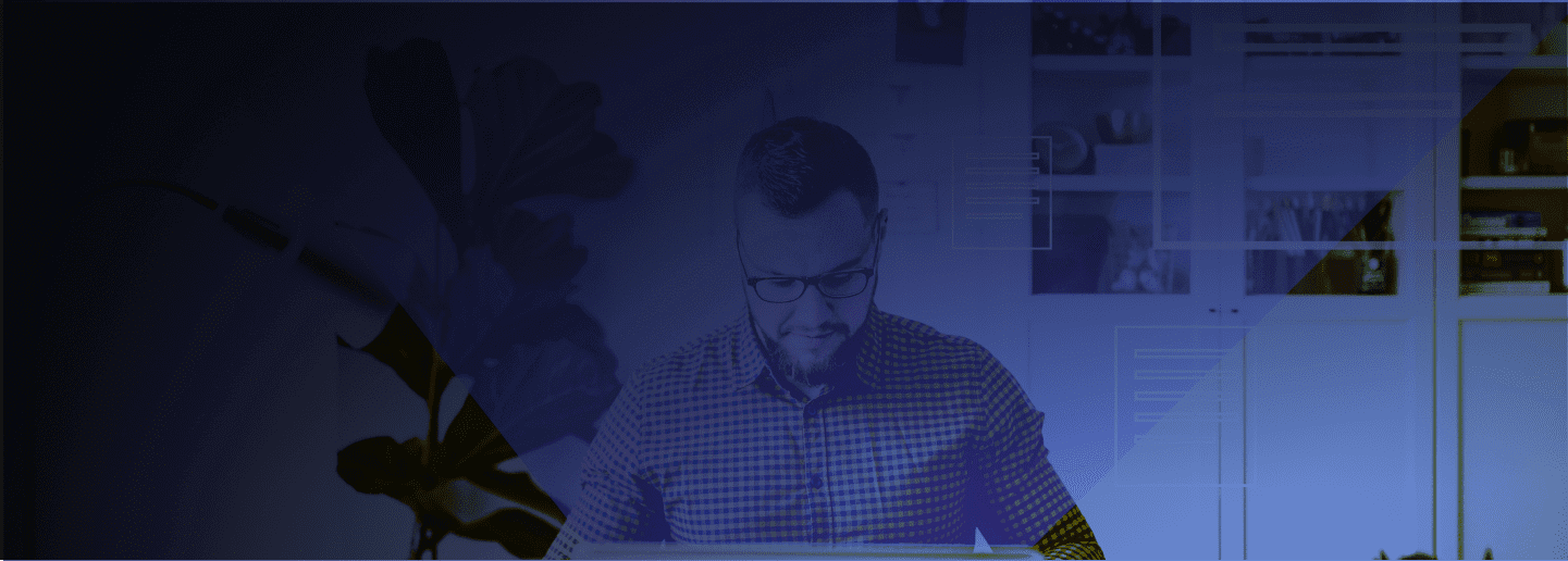 Photograph of a men looking down on a desk with a blue filter