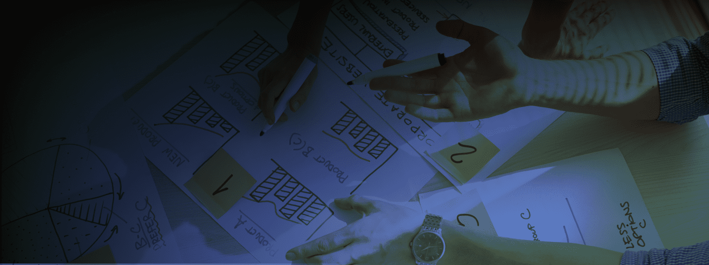 Photograph of a woman hand with brainstorming papers under it with a blue filter