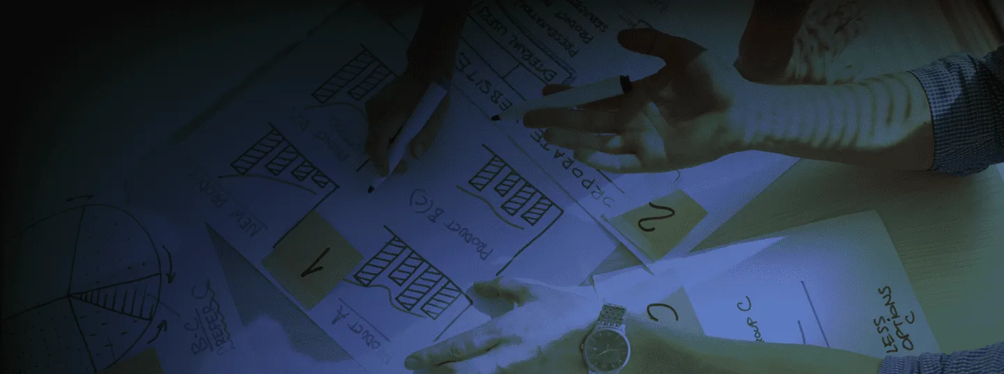 Photograph of a woman hand with brainstorming papers under it with a blue filter