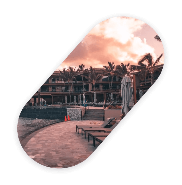 Oval photograph of a resort with palm trees